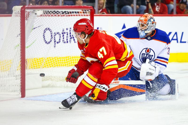 Sep 23, 2024; Calgary, Alberta, CAN; Calgary Flames center Connor Zary (47) scores a goal against Edmonton Oilers goaltender Olivier Rodrigue (35) during the second period at Scotiabank Saddledome. Mandatory Credit: Sergei Belski-Imagn Images