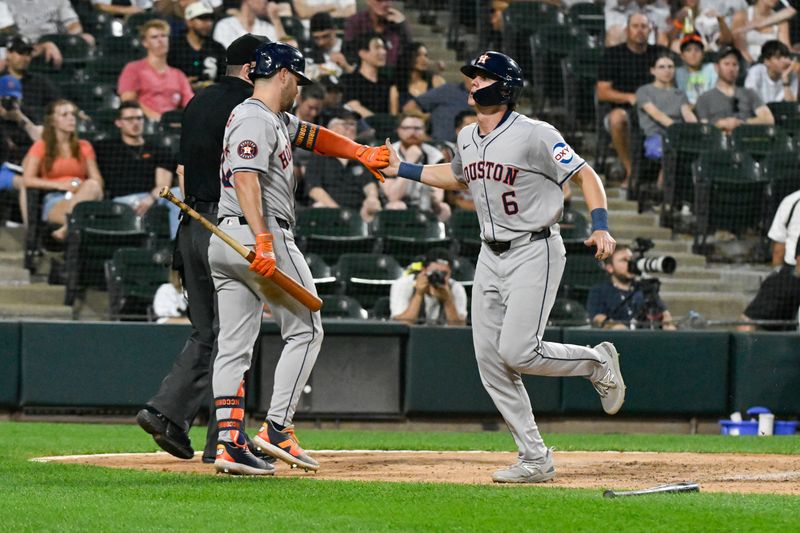 Jun 19, 2024; Chicago, Illinois, USA;  Houston Astros outfielder Chas McCormick (20) high fives outfielder Jake Meyers (6) after he scored against the Chicago White Sox during the sixth inning at Guaranteed Rate Field. Mandatory Credit: Matt Marton-USA TODAY Sports