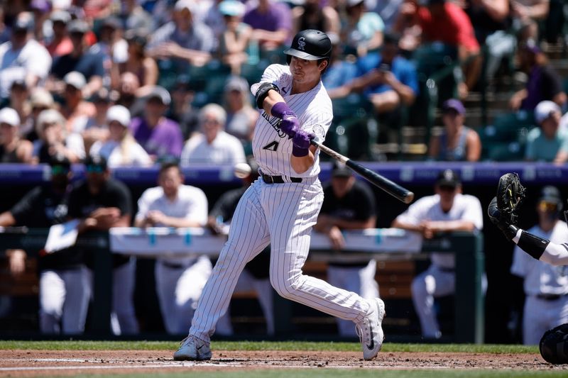 Jul 16, 2023; Denver, Colorado, USA; Colorado Rockies first baseman Michael Toglia (4) hits a solo home run in the second inning against the New York Yankees at Coors Field. Mandatory Credit: Isaiah J. Downing-USA TODAY Sports