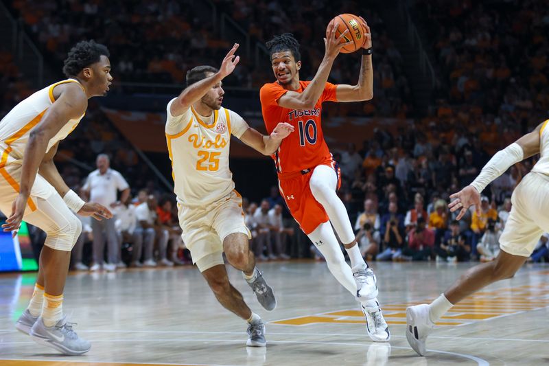 Feb 28, 2024; Knoxville, Tennessee, USA; Auburn Tigers guard Chad Baker-Mazara (10) moves the ball against Tennessee Volunteers guard Santiago Vescovi (25) during the first half at Thompson-Boling Arena at Food City Center. Mandatory Credit: Randy Sartin-USA TODAY Sports