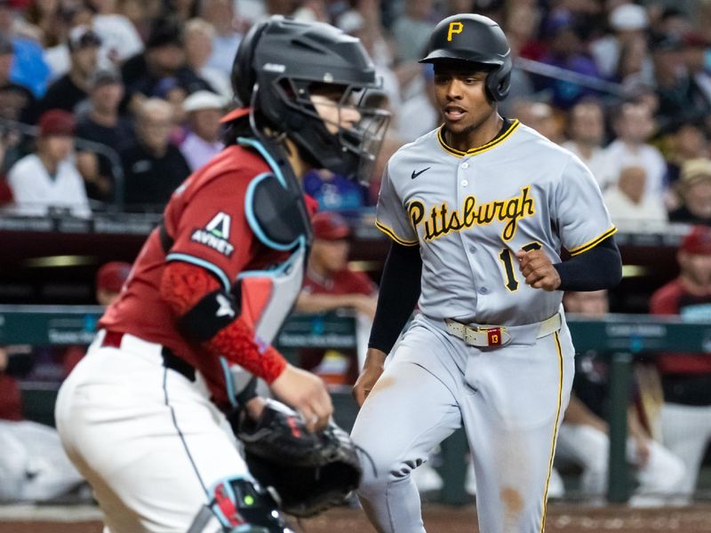 May 28, 2025; Phoenix, Arizona, USA; Pittsburgh Pirates base runner Ke'Bryan Hayes scores in the sixth inning against the Arizona Diamondbacks at Chase Field. Mandatory Credit: Mark J. Rebilas-Imagn Images