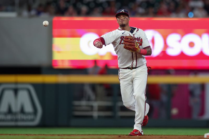 May 28, 2024; Atlanta, Georgia, USA; Atlanta Braves shortstop Orlando Arcia (11) throws a runner out at first against the Washington Nationals in the eighth inning at Truist Park. Mandatory Credit: Brett Davis-USA TODAY Sports
