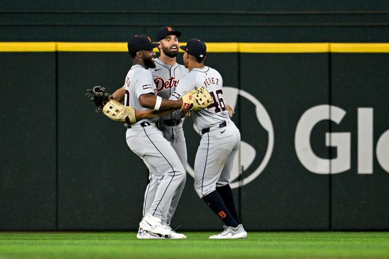 Jun 3, 2024; Arlington, Texas, USA; Detroit Tigers right fielder Wenceel Perez (46) and center fielder Riley Greene (31) and left fielder Akil Baddoo (60) celebrate the Tigers victory over the Texas Rangers at Globe Life Field. Mandatory Credit: Jerome Miron-USA TODAY Sports