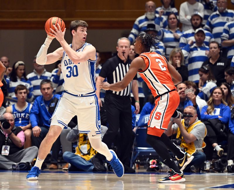 Jan 2, 2024; Durham, North Carolina, USA;  Duke Blue Devils center Kyle Filipowski (30) controls the ball in front of Syracuse Orange guard JJ Starling (2) during the first half at Cameron Indoor Stadium. Mandatory Credit: Rob Kinnan-USA TODAY Sports