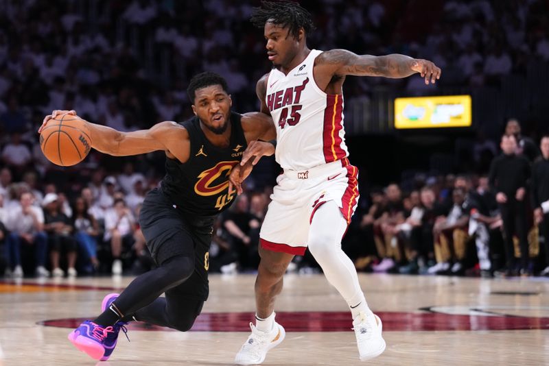 MIAMI, FLORIDA - APRIL 26: Donovan Mitchell #45 of the Cleveland Cavaliers dribbles the ball against Davion Mitchell #45 of the Miami Heat during the second quarter in Game Three of the Eastern Conference First Round NBA Playoffs at Kaseya Center on April 26, 2025 in Miami, Florida. NOTE TO USER: User expressly acknowledges and agrees that, by downloading and or using this photograph, User is consenting to the terms and conditions of the Getty Images License Agreement. (Photo by Rich Storry/Getty Images)