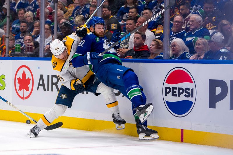 Apr 21, 2024; Vancouver, British Columbia, CAN; Nashville Predators forward Kiefer Sherwood (44) checks Vancouver Canucks defenseman Ian Cole (82) in the second period in game one of the first round of the 2024 Stanley Cup Playoffs at Rogers Arena. Mandatory Credit: Bob Frid-USA TODAY Sports