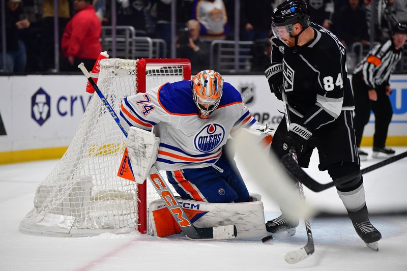 Dec 30, 2023; Los Angeles, California, USA; Edmonton Oilers goaltender Stuart Skinner (74) defends the goal against Los Angeles Kings defenseman Vladislav Gavrikov (84) during the overtime period at Crypto.com Arena. Mandatory Credit: Gary A. Vasquez-USA TODAY Sports