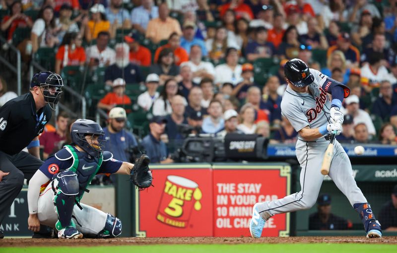 Jun 16, 2024; Houston, Texas, USA;  Detroit Tigers first fielder Mark Canha (21) hits a single against the Houston Astros in the ninth inning at Minute Maid Park. Mandatory Credit: Thomas Shea-USA TODAY Sports