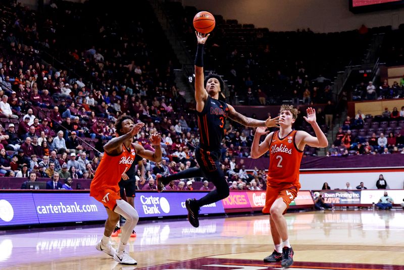 Jan 4, 2025; Blacksburg, Virginia, USA; Miami Hurricanes guard Jalil Bethea (3) shoots the ball against Virginia Tech Hokies guard Jaden Schutt (2) and forward Tobi Lawal (1) during the second half at Cassell Coliseum. Mandatory Credit: Peter Casey-Imagn Images