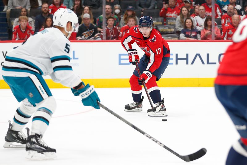 Oct 29, 2023; Washington, District of Columbia, USA; Washington Capitals center Dylan Strome (17) controls the puck as San Jose Sharks defenseman Matt Benning (5) defends during the first period at Capital One Arena. Mandatory Credit: Amber Searls-USA TODAY Sports