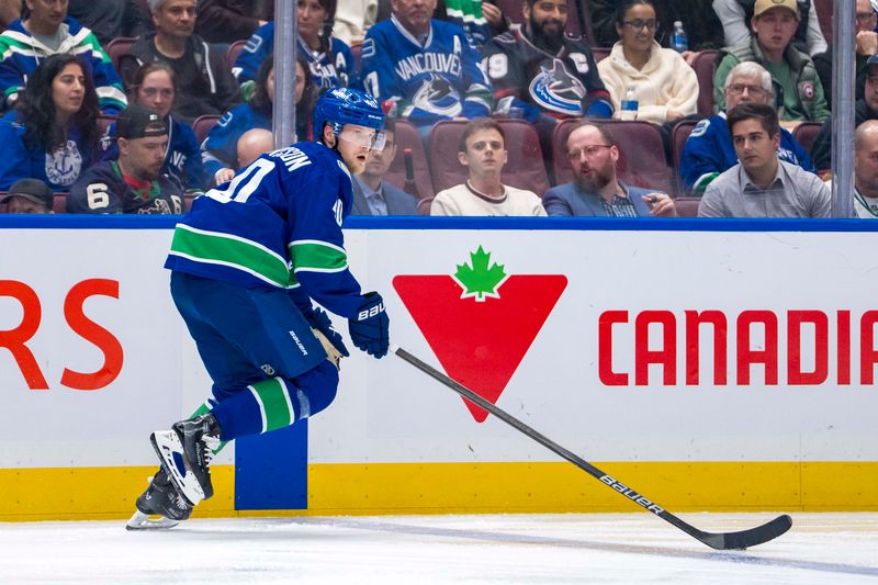 Oct 9, 2024; Vancouver, British Columbia, CAN; Vancouver Canucks forward Elias Pettersson (40) handles the puck against the Calgary Flames during the third period at Rogers Arena. Mandatory Credit: Bob Frid-Imagn Images