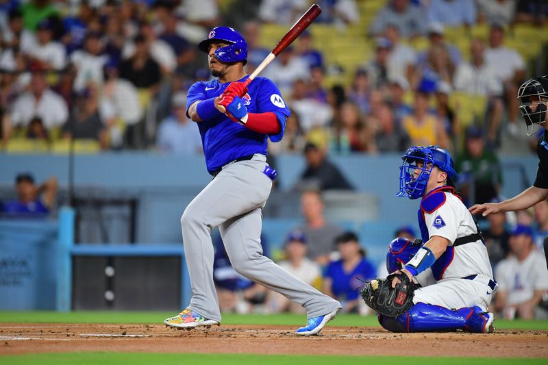 Sep 9, 2024; Los Angeles, California, USA; Chicago Cubs third baseman Isaac Paredes (17) hits a double against the Los Angeles Dodgers during the first inning at Dodger Stadium. Mandatory Credit: Gary A. Vasquez-Imagn Images