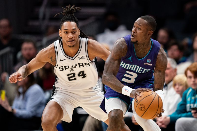 CHARLOTTE, NORTH CAROLINA - JANUARY 19: Devin Vassell #24 of the San Antonio Spurs guards Terry Rozier #3 of the Charlotte Hornets in the first quarter during their game at Spectrum Center on January 19, 2024 in Charlotte, North Carolina. NOTE TO USER: User expressly acknowledges and agrees that, by downloading and or using this photograph, User is consenting to the terms and conditions of the Getty Images License Agreement. (Photo by Jacob Kupferman/Getty Images)