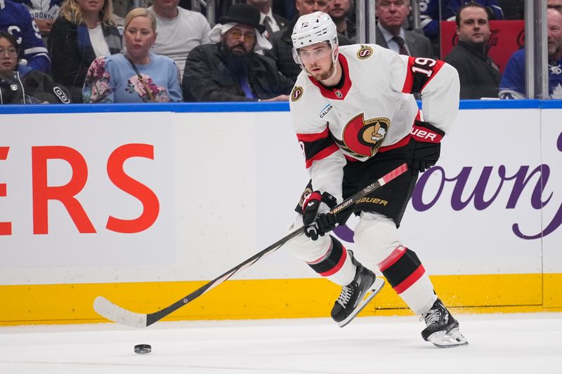 Apr 20, 2025; Toronto, Ontario, CAN; Ottawa Senators forward Drake Batherson (19) carries the puck against the Toronto Maple Leafs during the second period of game one of the first round of the 2025 Stanley Cup Playoffs at Scotiabank Arena. Mandatory Credit: John E. Sokolowski-Imagn Images