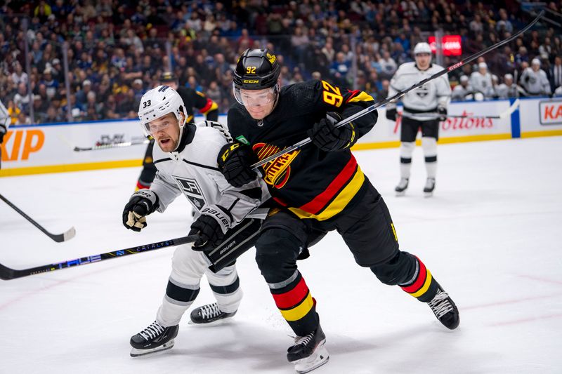 Mar 25, 2024; Vancouver, British Columbia, CAN; Los Angeles Kings forward Viktor Arvidsson (33) battles with Vancouver Canucks forward Vasily Podkolzin (92) in the first period at Rogers Arena. Mandatory Credit: Bob Frid-USA TODAY Sports