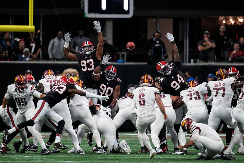 Washington Commanders place kicker Joey Slye (6) kicks a field goal against the Atlanta Falcons during the first half of an NFL football game, Sunday, Oct. 15, 2023, in Atlanta. (AP Photo/John Bazemore)