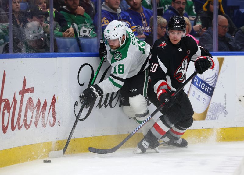 Feb 6, 2024; Buffalo, New York, USA;  Buffalo Sabres defenseman Henri Jokiharju (10) checks Dallas Stars center Sam Steel (18) as he goes after a loose puck during the first period at KeyBank Center. Mandatory Credit: Timothy T. Ludwig-USA TODAY Sports