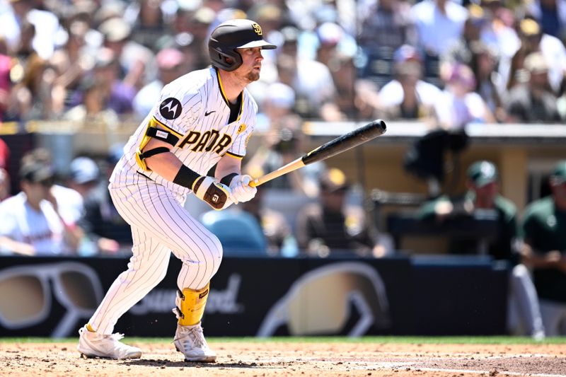 Jun 12, 2024; San Diego, California, USA; San Diego Padres second baseman Jake Cronenworth (9) hits a single against the Oakland Athletics during the fourth inning at Petco Park. Mandatory Credit: Orlando Ramirez-USA TODAY Sports