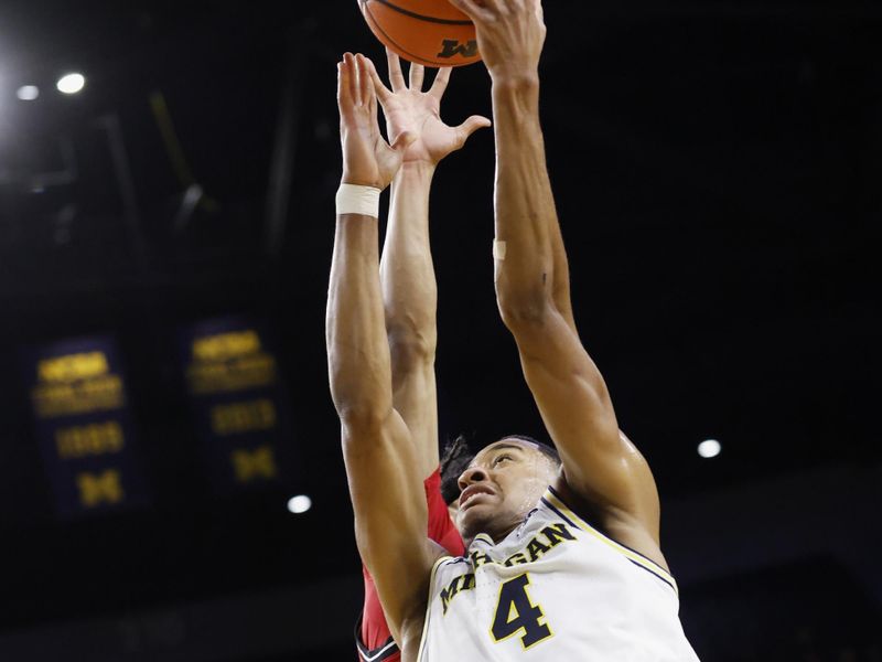 Feb 27, 2025; Ann Arbor, Michigan, USA;  Michigan Wolverines guard Nimari Burnett (4) goes to the basket in the first half against the Rutgers Scarlet Knights at Crisler Center. Mandatory Credit: Rick Osentoski-Imagn Images