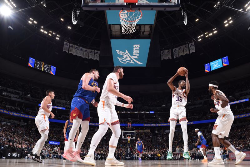 DENVER, CO - MARCH 5: Kevin Durant #35 of the Phoenix Suns rebounds the ball during the game against the Denver Nuggets on March 5, 2024 at the Ball Arena in Denver, Colorado. NOTE TO USER: User expressly acknowledges and agrees that, by downloading and/or using this Photograph, user is consenting to the terms and conditions of the Getty Images License Agreement. Mandatory Copyright Notice: Copyright 2024 NBAE (Photo by Garrett Ellwood/NBAE via Getty Images)