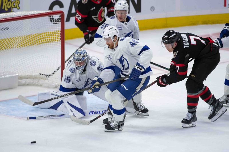 Oct 19, 2024; Ottawa, Ontario, CAN; Tampa Bay Lightning goalie Andrei Vasilevskiy (88) follows the puck as defenseman Nick Perbix (48) and Ottawa Senators left wing Brady Tkachuk (7) give chase in the third period at the Canadian Tire Centre. Mandatory Credit: Marc DesRosiers-Imagn Images