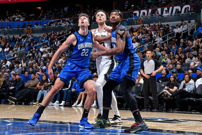 ORLANDO, FL - FEBRUARY 8: Wendell Carter Jr. #34 and Franz Wagner #22 of the Orlando Magic box out during the game against the San Antonio Spurs on February 8, 2024 at the Kia Center in Orlando, Florida. NOTE TO USER: User expressly acknowledges and agrees that, by downloading and or using this photograph, User is consenting to the terms and conditions of the Getty Images License Agreement. Mandatory Copyright Notice: Copyright 2024 NBAE (Photo by Gary Bassing/NBAE via Getty Images)