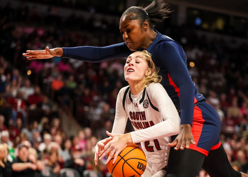 Feb 4, 2024; Columbia, South Carolina, USA; Ole Miss Rebels forward Tyia Singleton (22) collides with South Carolina Gamecocks forward Chloe Kitts (21) in the first half at Colonial Life Arena. Mandatory Credit: Jeff Blake-USA TODAY Sports