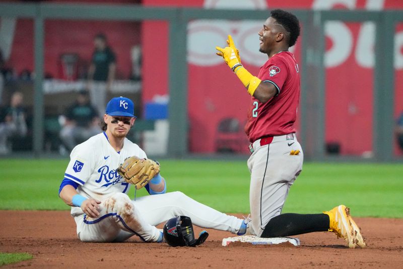 Jul 24, 2024; Kansas City, Missouri, USA; Arizona Diamondbacks shortstop Geraldo Perdomo (2) celebrates after stealing second base as Kansas City Royals shortstop Bobby Witt Jr. (7) looks on in the fifth inning at Kauffman Stadium. Mandatory Credit: Denny Medley-USA TODAY Sports