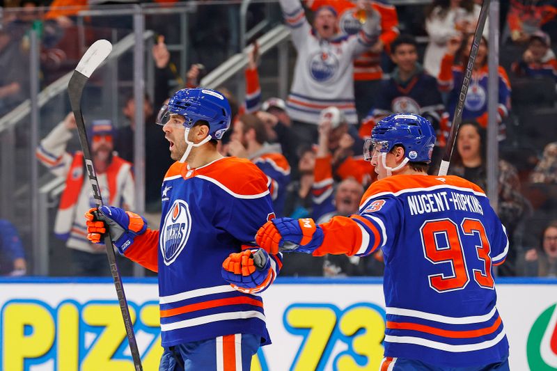 Nov 12, 2024; Edmonton, Alberta, CAN; The Edmonton Oilers celebrate a goal scored by defensemen Evan Bouchard (2) during the third period against the New York Islanders at Rogers Place. Mandatory Credit: Perry Nelson-Imagn Images