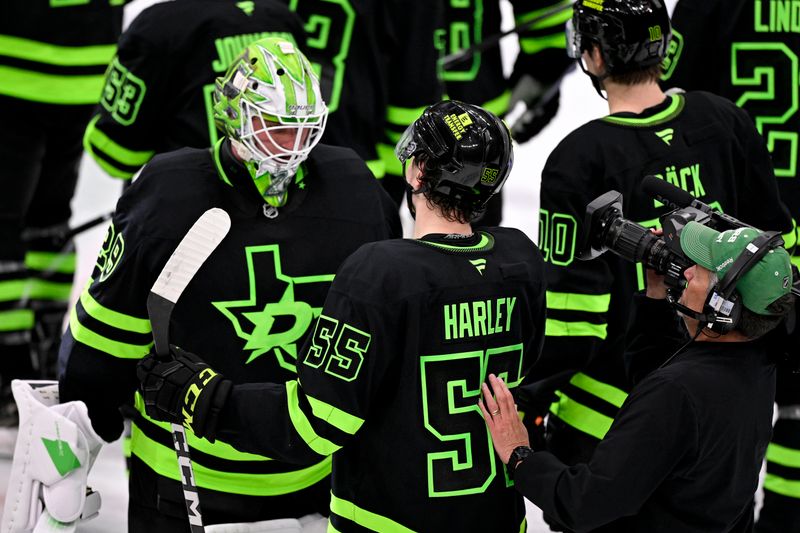 Mar 22, 2025; Dallas, Texas, USA; Dallas Stars defenseman Thomas Harley (55) and goaltender Jake Oettinger (29) celebrates after Harley scores the game winning goal against the Philadelphia Flyers during the overtime period at the American Airlines Center. Mandatory Credit: Jerome Miron-Imagn Images