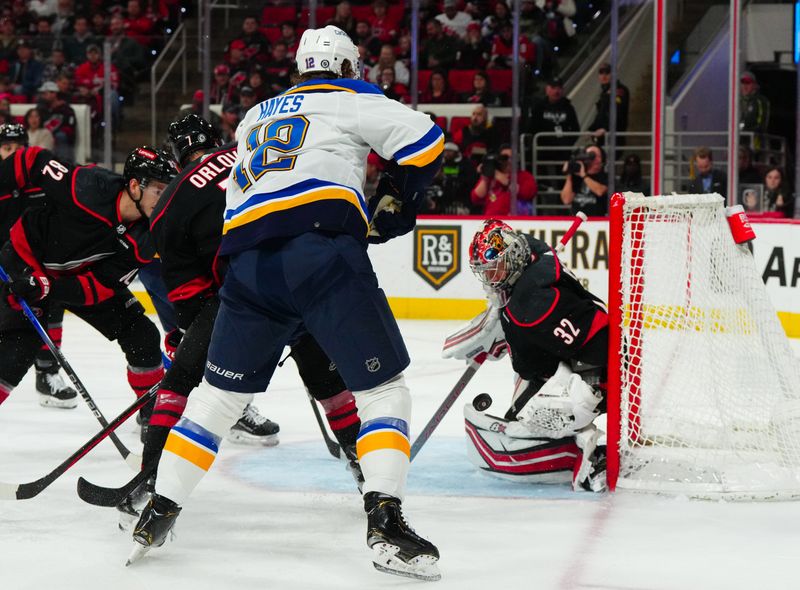 Jan 6, 2024; Raleigh, North Carolina, USA; Carolina Hurricanes goaltender Antti Raanta (32) stops the shot attempt by St. Louis Blues right wing Kevin Hayes (12) during the second period at PNC Arena. Mandatory Credit: James Guillory-USA TODAY Sports