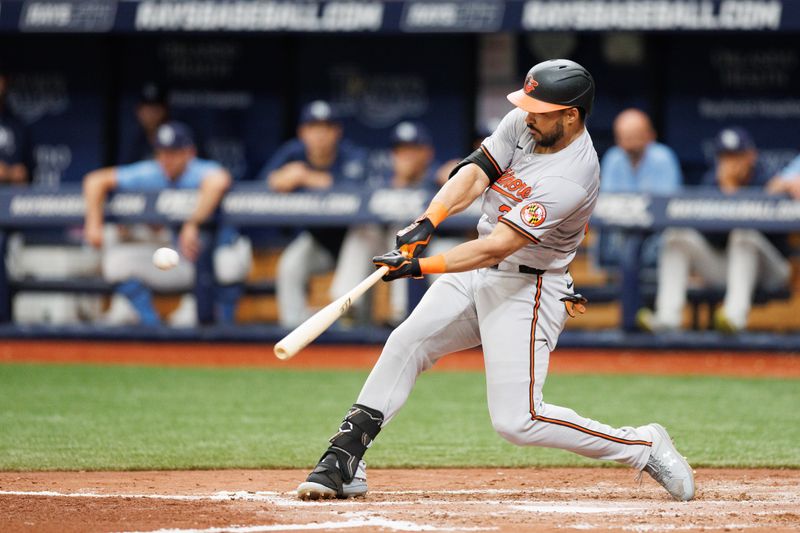 Jun 9, 2024; St. Petersburg, Florida, USA;  Baltimore Orioles outfielder Anthony Santander (25) hits a home run against the Tampa Bay Rays in the fourth inning at Tropicana Field. Mandatory Credit: Nathan Ray Seebeck-USA TODAY Sports