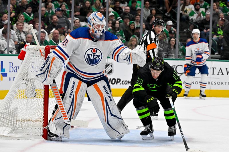 Apr 3, 2024; Dallas, Texas, USA; Dallas Stars center Logan Stankoven (11) skates under the glove of Edmonton Oilers goaltender Calvin Pickard (30) during the second period at the American Airlines Center. Mandatory Credit: Jerome Miron-USA TODAY Sports
