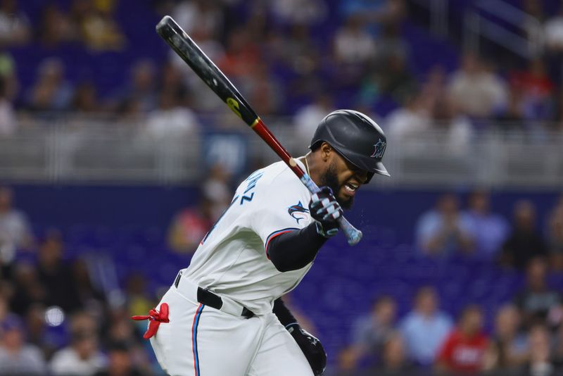 Jun 5, 2024; Miami, Florida, USA; Miami Marlins left fielder Bryan De La Cruz (14) reacts after flying out against the Tampa Bay Rays during the fifth inning at loanDepot Park. Mandatory Credit: Sam Navarro-USA TODAY Sports