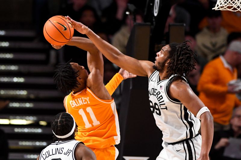 Jan 18, 2025; Nashville, Tennessee, USA;  Vanderbilt Commodores forward Devin McGlockton (99) blocks the shot of Tennessee Volunteers guard Jordan Gainey (11) during the first half at Memorial Gymnasium. Mandatory Credit: Steve Roberts-Imagn Images