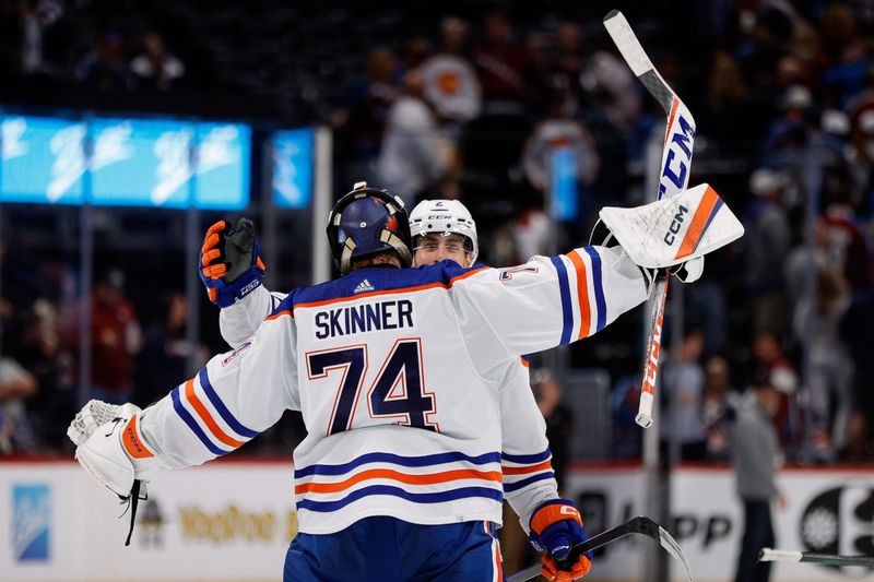 Apr 11, 2023; Denver, Colorado, USA; Edmonton Oilers defenseman Evan Bouchard (2) celebrates with goaltender Stuart Skinner (74) after the game against the Colorado Avalanche at Ball Arena. Mandatory Credit: Isaiah J. Downing-USA TODAY Sports