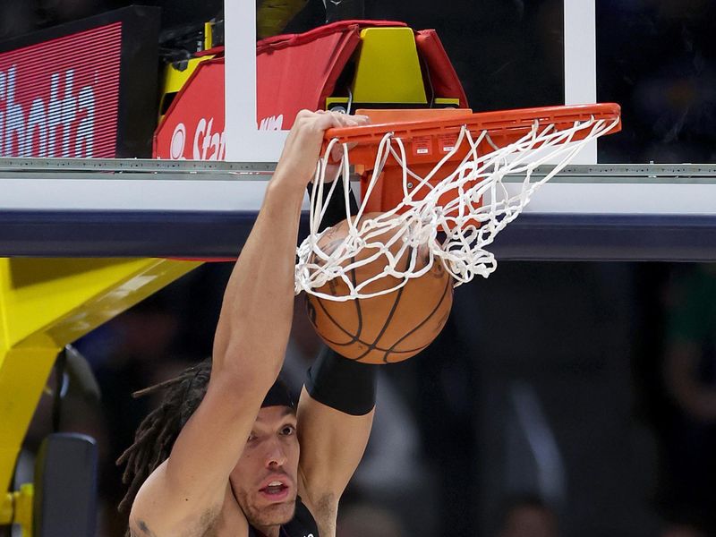 DENVER, COLORADO - DECEMBER 18: Aaron Gordon #50 of the Denver Nuggets dunks over Dante Exum #0 of the Dallas Mavericks in the first quarter at Ball Arena on December 18, 2023 in Denver, Colorado. NOTE TO USER: User expressly acknowledges and agrees that, by downloading and or using this photograph, User is consenting to the terms and conditions of the Getty Images License Agreement.   (Photo by Matthew Stockman/Getty Images)