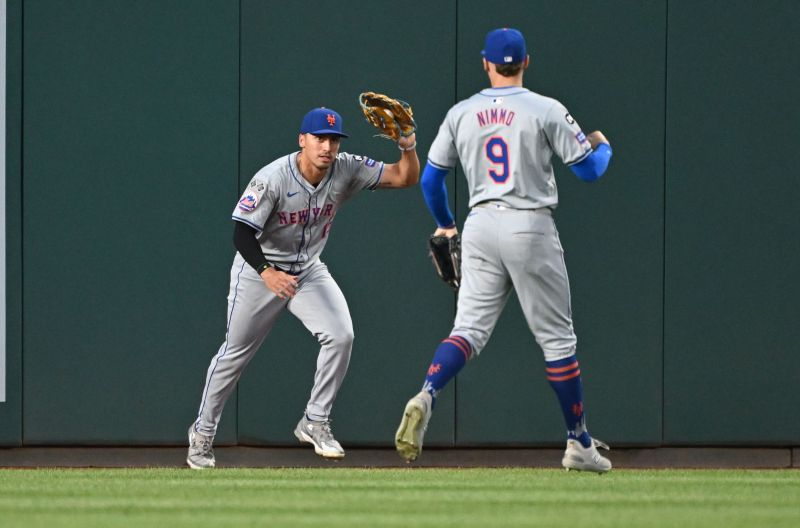 Jul 2, 2024; Washington, District of Columbia, USA; New York Mets right fielder Tyrone Taylor (15) shows the ball to left fielder Brandon Nimmo (9) after catching the ball at the wall against the Washington Nationals during the seventh inning at Nationals Park. Mandatory Credit: Rafael Suanes-USA TODAY Sports