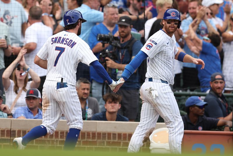 Aug 17, 2025; Chicago, Illinois, USA; Chicago Cubs catcher Carson Kelly (15) celebrates with shortstop Dansby Swanson (7) after scoring during the eighth inning against the Pittsburgh Pirates at Wrigley Field. Mandatory Credit: Melissa Tamez-Imagn Images