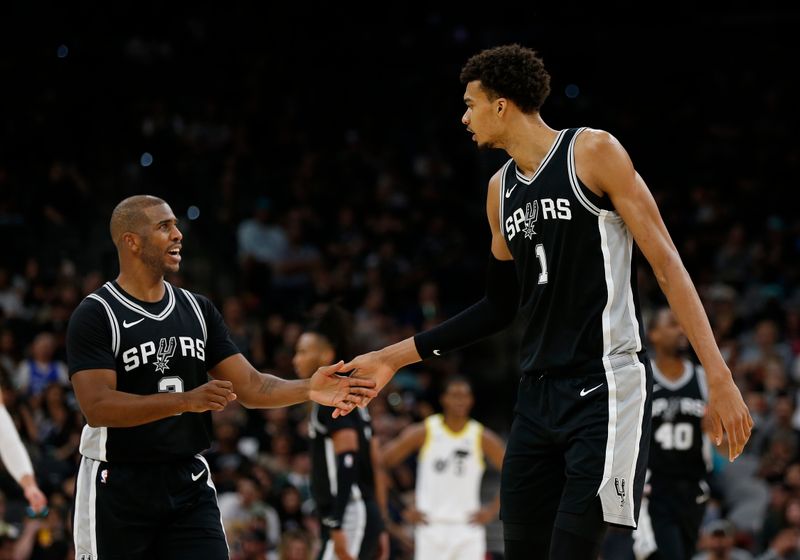 SAN ANTONIO, TX - NOVEMBER 9:  Chris Paul #3 of the San Antonio Spurs take with Victor Wembanyama #1 during game against the Utah Jazz in the second half at Frost Bank Center on November 9, 2024 in San Antonio, Texas. NOTE TO USER: User expressly acknowledges and agrees that, by downloading and or using this photograph, User is consenting to terms and conditions of the Getty Images License Agreement. (Photo by Ronald Cortes/Getty Images)