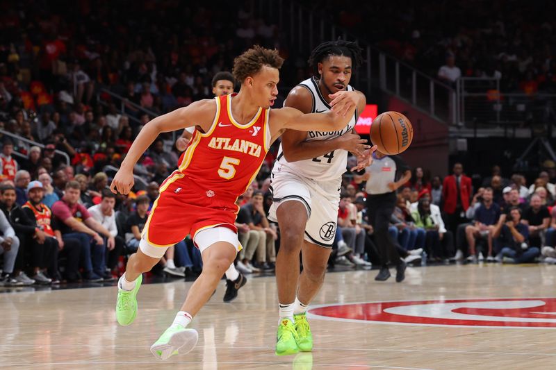 ATLANTA, GEORGIA - OCTOBER 23: Dyson Daniels #5 of the Atlanta Hawks and Cam Thomas #24 of the Brooklyn Nets compete for the ball during the second quarter at State Farm Arena on October 23, 2024 in Atlanta, Georgia. NOTE TO USER: User expressly acknowledges and agrees that, by downloading and or using this photograph, User is consenting to the terms and conditions of the Getty Images License Agreement. (Photo by Kevin C. Cox/Getty Images)