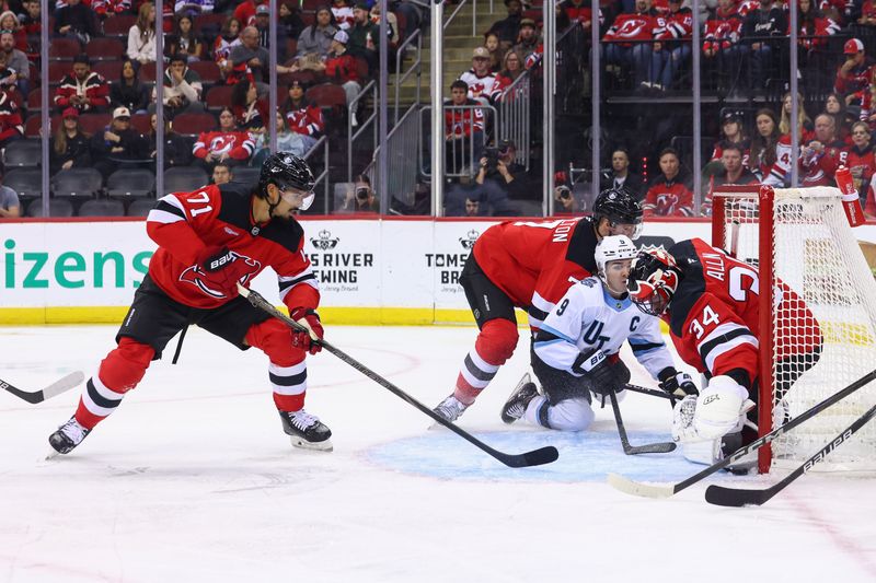 Oct 14, 2024; Newark, New Jersey, USA; New Jersey Devils goaltender Jake Allen (34) makes a save against the Utah Hockey Club during the first period at Prudential Center. Mandatory Credit: Ed Mulholland-Imagn Images