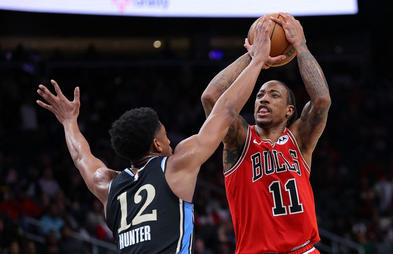 ATLANTA, GEORGIA - FEBRUARY 12:  DeMar DeRozan #11 of the Chicago Bulls attempts a shot against De'Andre Hunter #12 of the Atlanta Hawks during the fourth quarter at State Farm Arena on February 12, 2024 in Atlanta, Georgia.  NOTE TO USER: User expressly acknowledges and agrees that, by downloading and/or using this photograph, user is consenting to the terms and conditions of the Getty Images License Agreement.  (Photo by Kevin C. Cox/Getty Images)