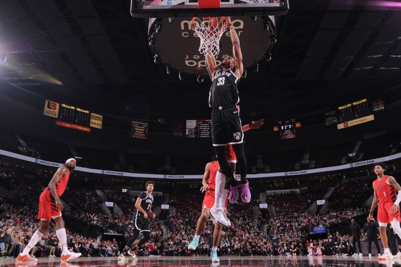 PORTLAND, OR - JANUARY 17: Nicolas Claxton #33 of the Brooklyn Nets dunks the ball during the game against the Portland Trail Blazers on January 17, 2024 at the Moda Center Arena in Portland, Oregon. NOTE TO USER: User expressly acknowledges and agrees that, by downloading and or using this photograph, user is consenting to the terms and conditions of the Getty Images License Agreement. Mandatory Copyright Notice: Copyright 2024 NBAE (Photo by Cameron Browne/NBAE via Getty Images)