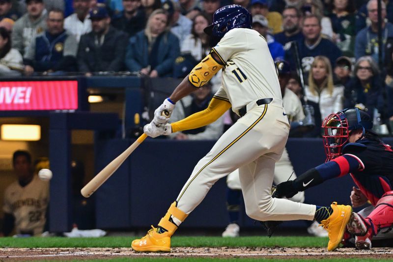 Apr 2, 2024; Milwaukee, Wisconsin, USA; Milwaukee Brewers center fielder Jackson Chourio (11) hits a single to drive in a run in the second inning against the Minnesota Twins at American Family Field. Mandatory Credit: Benny Sieu-USA TODAY Sports