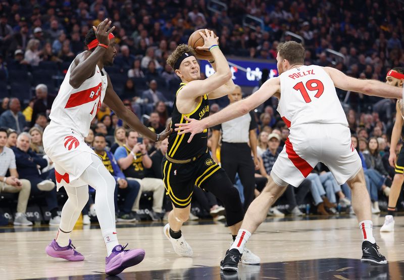 SAN FRANCISCO, CALIFORNIA - JANUARY 07: Brandin Podziemski #2 of the Golden State Warriors drives to the basket against Pascal Siakam #43 and Jakob Poeltl #19 of the Toronto Raptors in the first quarter at Chase Center on January 07, 2024 in San Francisco, California. NOTE TO USER: User expressly acknowledges and agrees that, by downloading and or using this photograph, User is consenting to the terms and conditions of the Getty Images License Agreement. (Photo by Lachlan Cunningham/Getty Images)