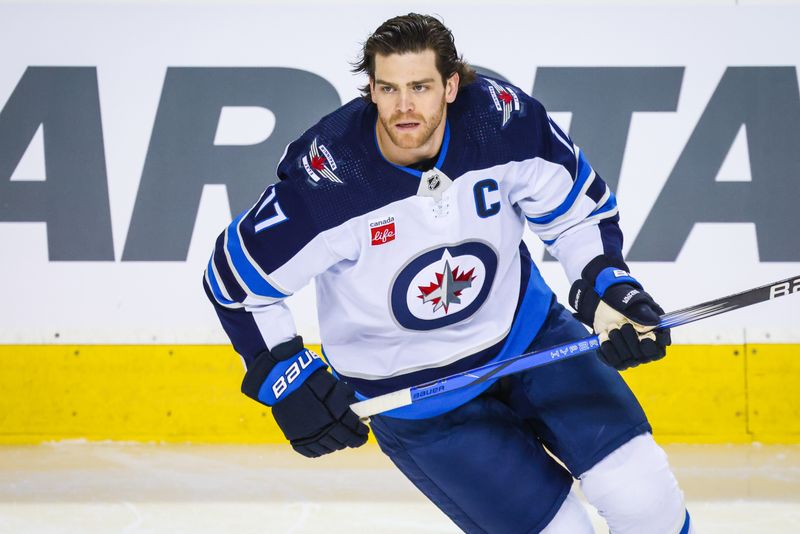 Feb 19, 2024; Calgary, Alberta, CAN; Winnipeg Jets center Adam Lowry (17) skates during the warmup period against the Calgary Flames at Scotiabank Saddledome. Mandatory Credit: Sergei Belski-USA TODAY Sports