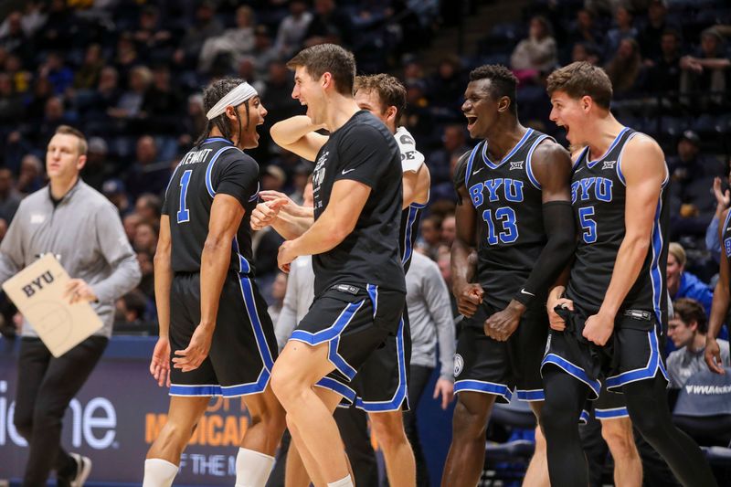 Feb 11, 2025; Morgantown, West Virginia, USA; Brigham Young Cougars guard Trey Stewart (1) celebrates with teammates after a timeout is called during the first half against the West Virginia Mountaineers at WVU Coliseum. Mandatory Credit: Ben Queen-Imagn Images