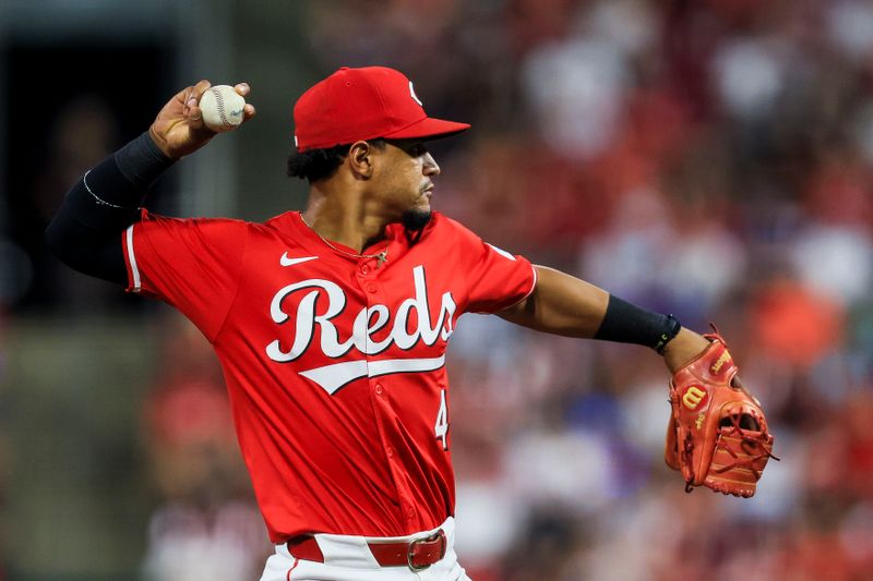 May 25, 2024; Cincinnati, Ohio, USA; Cincinnati Reds third baseman Santiago Espinal (4) throws to first to get Los Angeles Dodgers shortstop Mookie Betts (not pictured) out in the eighth inning at Great American Ball Park. Mandatory Credit: Katie Stratman-USA TODAY Sports