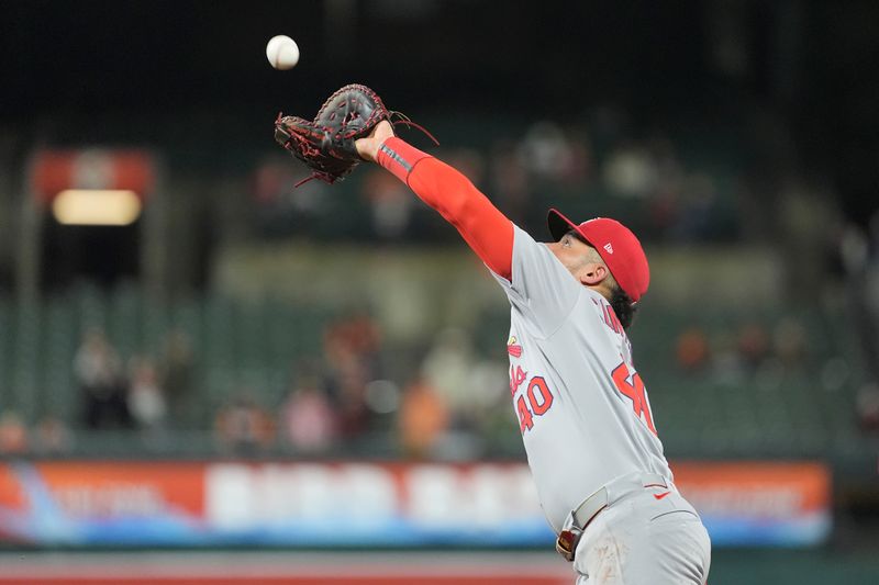May 28, 2025; Baltimore, Maryland, USA; St. Louis Cardinals first baseman Willson Contreras (40) catches a fly ball hit by Baltimore Orioles center fielder Dylan Carlson (15) (not pictured) during the eighth inning at Oriole Park at Camden Yards. Mandatory Credit: Gregory Fisher-Imagn Images